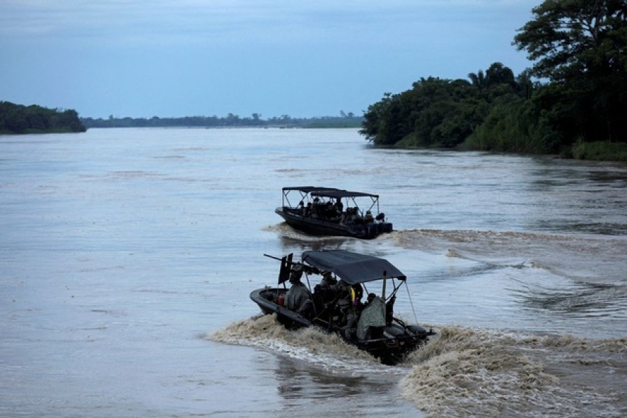 Colombian soldiers patrol by boat on the Arauca River, at the border between Colombia and Venezuela, as seen from Arauquita, Colombia March 28, 2021 – Reuters/Files