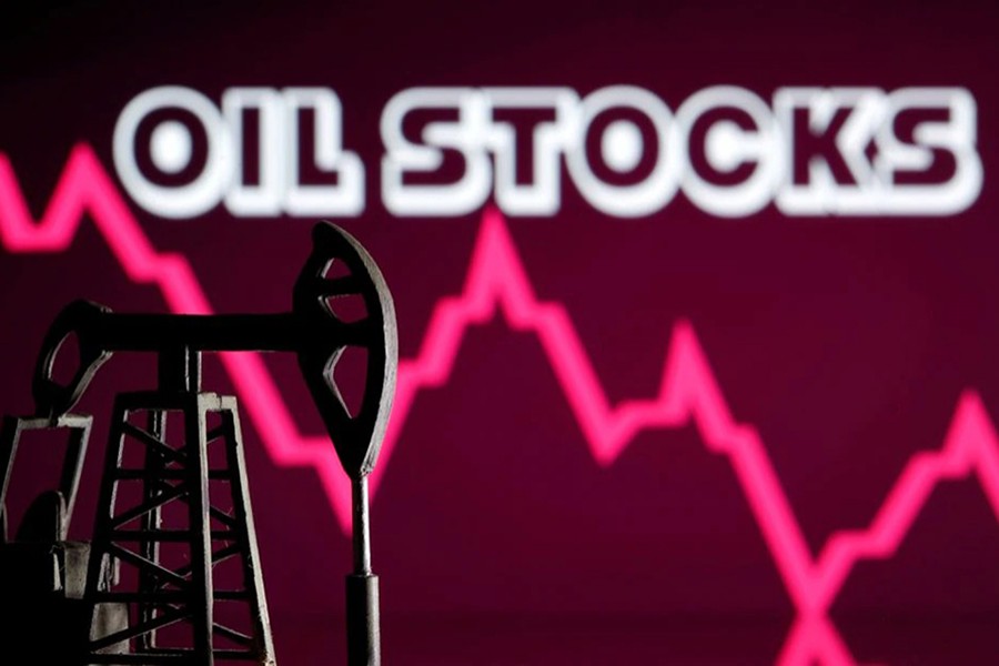 A 3D printed oil pump jack is seen in front of displayed stock graph and "Oil Stocks" words in this illustration picture — Reuters/Files