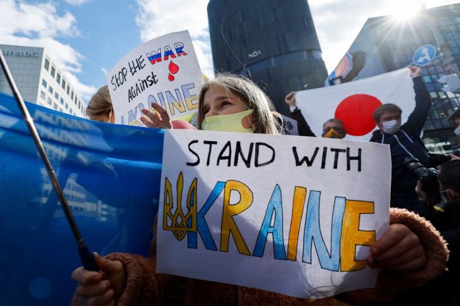 A Ukrainian residing in Japan shows a placard during a protest rally denouncing Russia over its actions in Ukraine, near Russian embassy in Tokyo, Japan February 23, 2022. REUTERS/Issei Kato