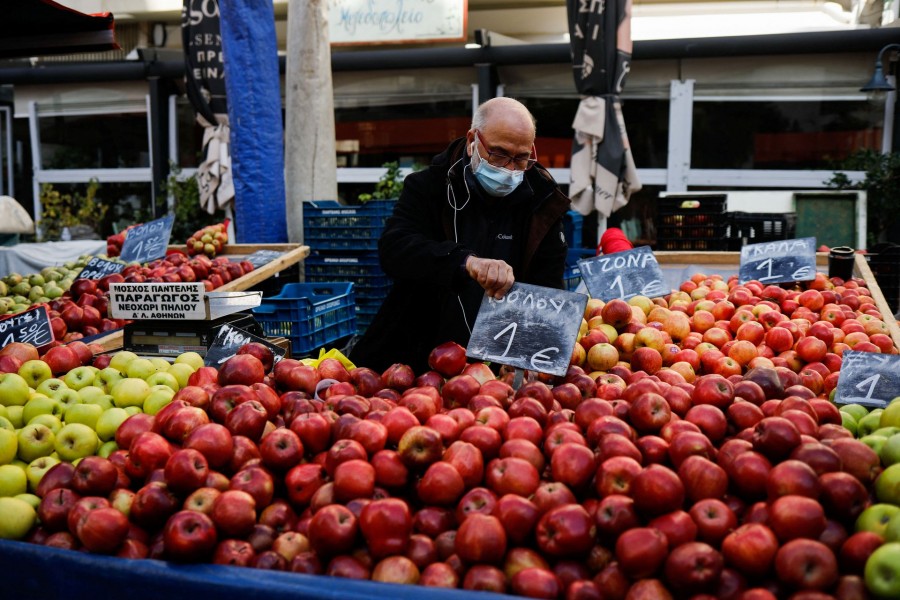 President of the federation of street market producers, Pantelis Moschos, waits for customers at a farmers market in Athens, Greece on February 10, 2022 — Reuters/Files