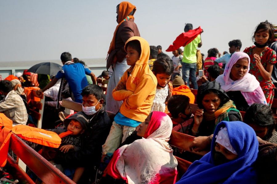 Rohingya refugees sit on wooden benches of a navy vessel on their way to the Bhasan Char island in Noakhali district  Rohingya refugees sit on wooden benches of a navy vessel on their way to the Bhasan Char island in Noakhali district, Bangladesh on December 29, 2020 — Reuters/Files