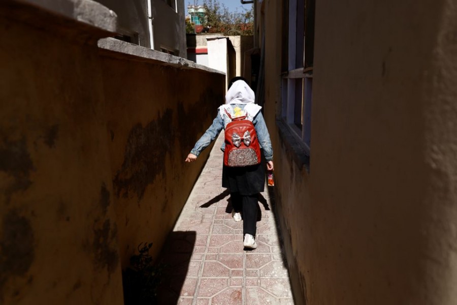 A 4th grade primary school student, walks back from school through an alleyway near her home in Kabul, Afghanistan, October 20, 2021. REUTERS/Zohra Bensemra/File Photo