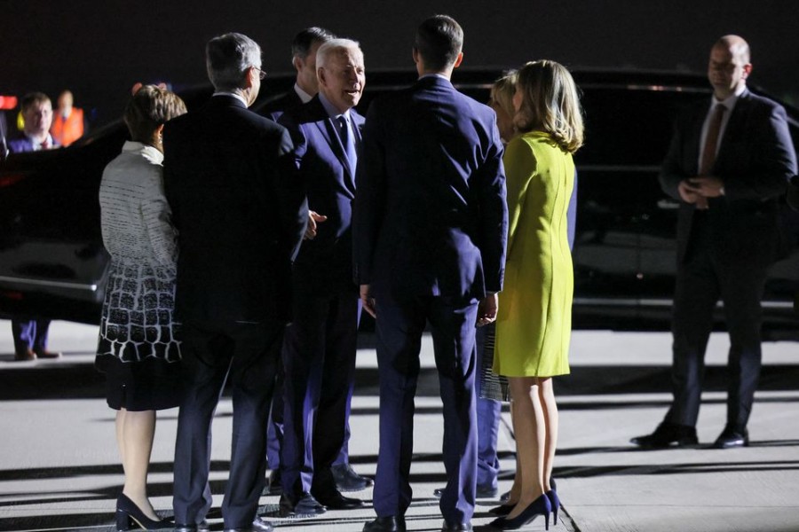 A Belgian delegation welcomes US President Joe Biden, who arrives to attend an extraordinary NATO summit to discuss ongoing deterrence and defence efforts in response to Russia's attack on Ukraine, in Brussels, Belgium, March 23, 2022. REUTERS/Evelyn Hockstein