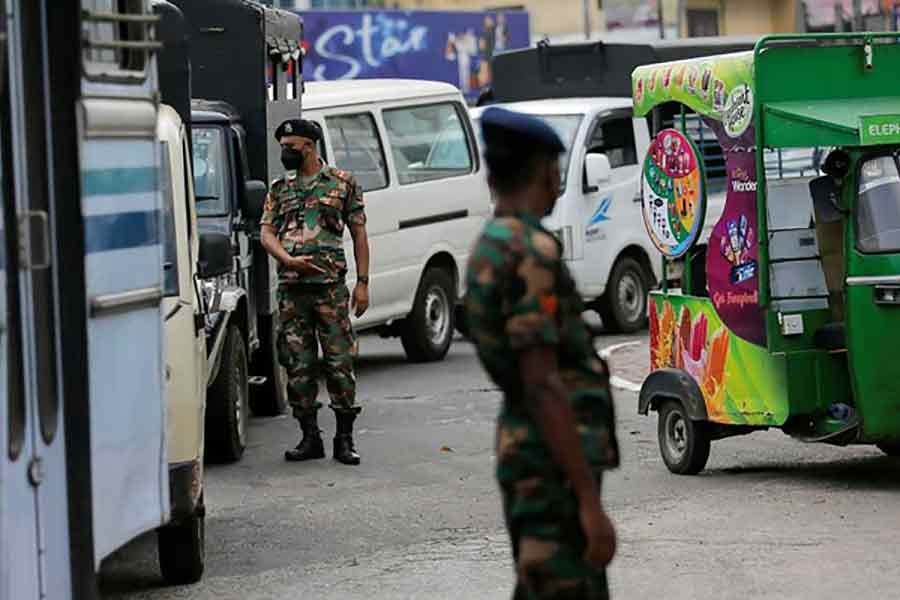 Sri Lanka's Army members standing guard at a Ceylon Petroleum Corporation fuel station in Colombo of Sri Lanka on March 22 to help stations distribute oil during the fuel crisis–Reuters file photo