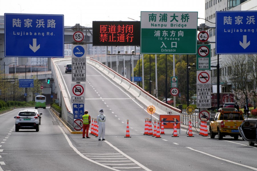 A police officer in a protective suit keeps watch next to a bridge leading to the Pudong area across the Huangpu river, after traffic restrictions amid the lockdown to contain the spread of the coronavirus disease (Covid-19) in Shanghai, China on March 28, 2022 — Reuters photo