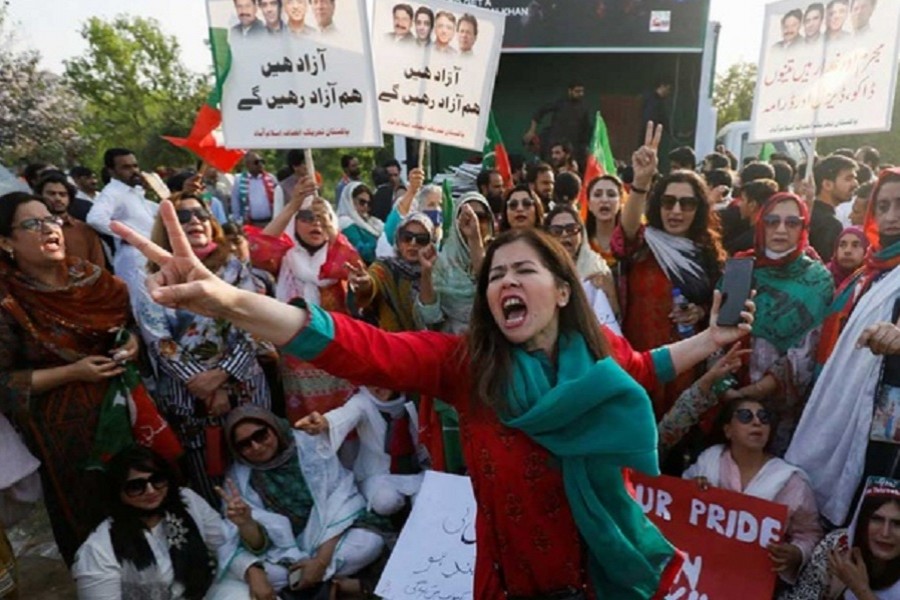 Supporters of the Pakistan Tehreek-e-Insaf (PTI) political party, carry signs as they chant slogans accusing the US of plotting to overthrow Pakistani Prime Minister Imran Khan, during a protest in Islamabad, Pakistan April 2, 2022. Reuters