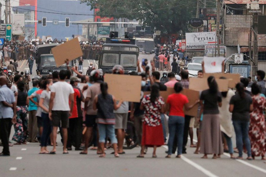 People attend a protest against Sri Lankan President Gotabaya Rajapaksa in a residential area after the government imposed a curfew following a clash between police and protestors near the President's residence during a protest amid the country's economic crisis, in Colombo, Sri Lanka on April 3, 2022 — Reuters photos