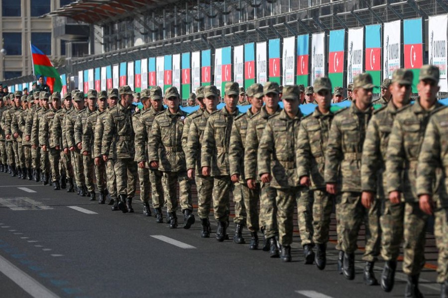 Azeri service members take part in a procession marking the anniversary of the end of the 2020 military conflict over Nagorno-Karabakh breakaway region, involving Azerbaijan's troops against ethnic Armenian forces, in Baku, Azerbaijan, November 8, 2021. REUTERS/Aziz Karimov/File Photo