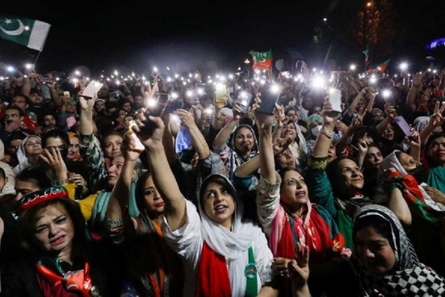 Supporters of the Pakistan Tehreek-e-Insaf (PTI) political party light up their mobile phones and chant slogans in support of Pakistani Prime Minister Imran Khan during a rally, in Islamabad, Pakistan April 4, 2022. Reuters