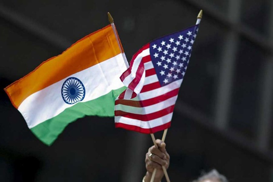 A man holds the flags of India and the US while people take part in the 35th India Day Parade in New York Aug 16, 2015. Reuters