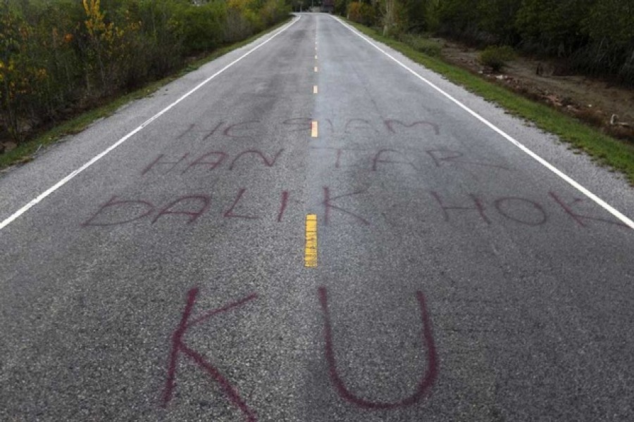 Separatist graffiti is seen on a road near Pattani June 6, 2014, one of three southernmost provinces of Thailand where government troops have fought Muslim insurgents since 2004. Graffiti reads "Hey Siamese - bring back our rights" – Reuters/Files