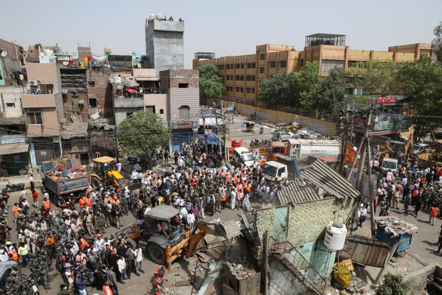 Police officials and members of security forces oversee the demolition of small illegal retail shops by civic authorities in a communally sensitive area in Jahangirpuri, in New Delhi, India, April 20, 2022. REUTERS/ Anushree Fadnavis