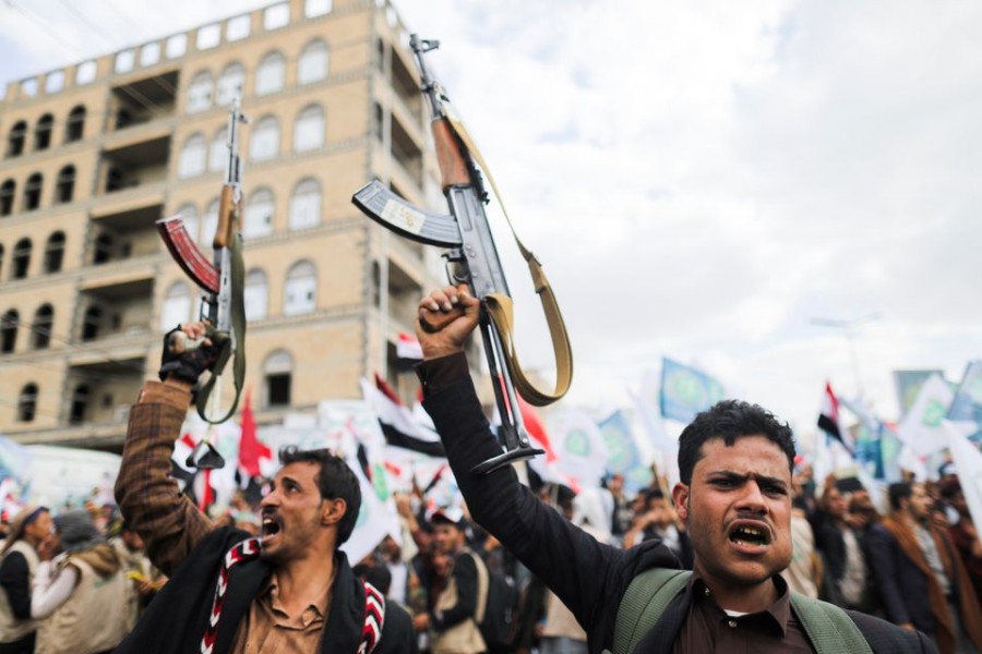 Supporters of Yemen's Houthis hold up their rifles as they rally to celebrate the seventh anniversary of the ousting of the government in Sanaa, Yemen September 21, 2021. REUTERS/Khaled Abdullah