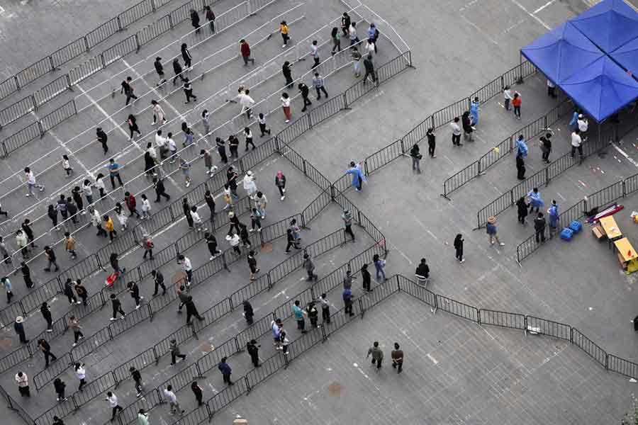 Residents lining up at a makeshift nucleic acid testing site during a mass testing for the coronavirus in Beijing of China on Monday –Reuters photo