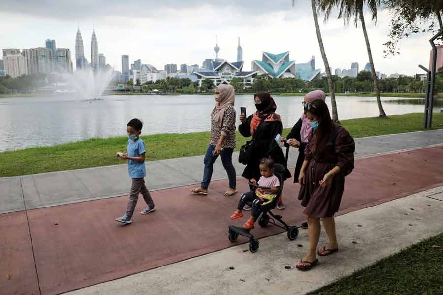 People wearing protective masks walk at a park, amid the coronavirus disease (Covid-19) pandemic, in Kuala Lumpur of Malaysia last year –Reuters file photo