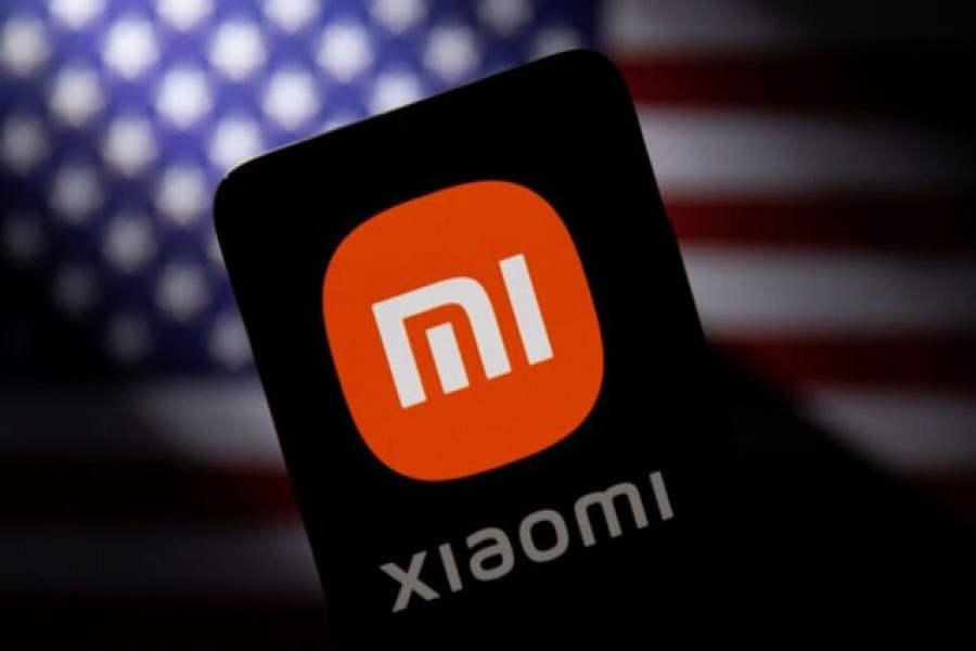 Smartphone with a Xiaomi logo is seen in front of a US flag in this illustration taken September 28, 2021 – Reuters/Dado Ruvic/Illustration