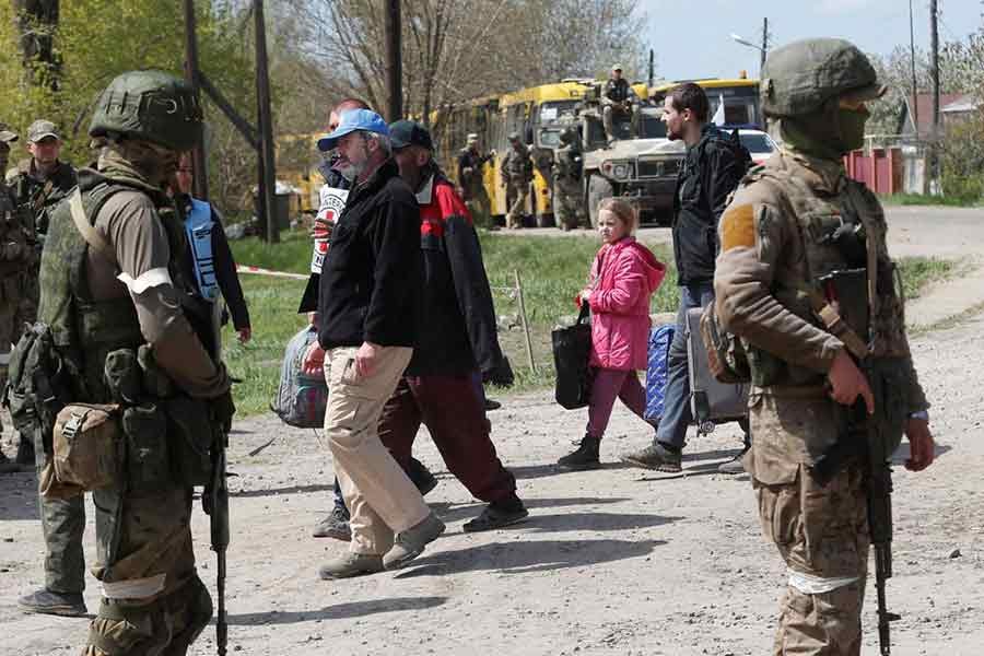 Civilians who left the area near Azovstal steel plant in Mariupol walking accompanied by UN staff and a member of the International Committee of the Red Cross (ICRC) at a temporary accommodation centre during Ukraine-Russia conflict in the village of Bezimenne in the Donetsk Region of Ukraine on Sunday –Reuters photo