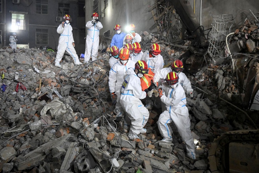 Rescue workers carry a survivor on a stretcher more than 131 hours after a building collapsed in Changsha, Hunan province, China, early May 5, 2022 — cnsphoto via REUTERS