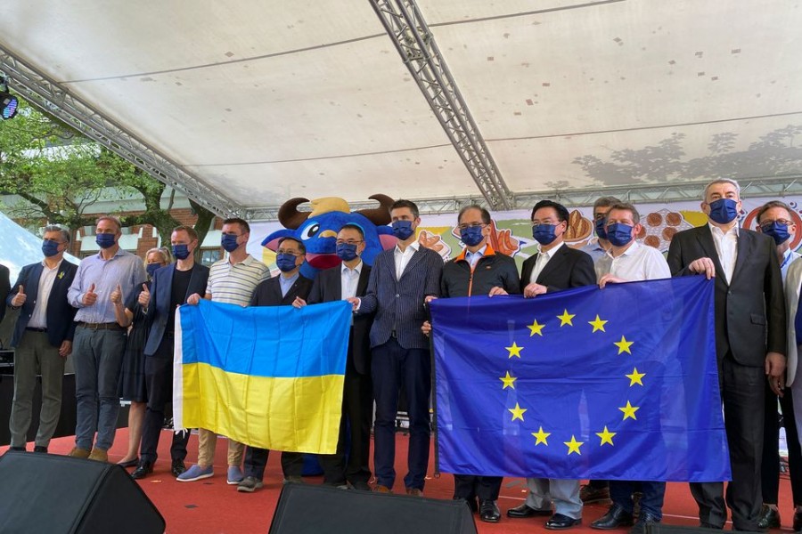 Head of European Economic and Trade Office (EETO) Filip Grzegorzewski, holds EU and Ukrainian flags next to Taiwan Parliament speaker You Si-kun, Foreign Minister Joseph Wu and other European diplomats at an Europe Day event in Taipei, Taiwan May 7, 2022. REUTERS/Ben Blanchard