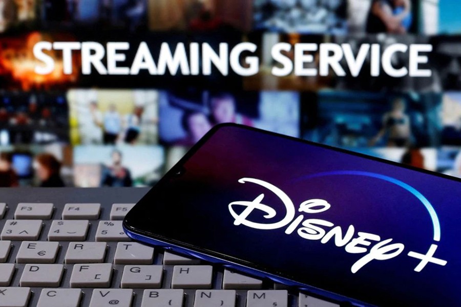 A smartphone with displayed "Disney" logo is seen on the keyboard in front of displayed "Streaming service" words in this illustration taken on March 24, 2020 — Reuters/Files