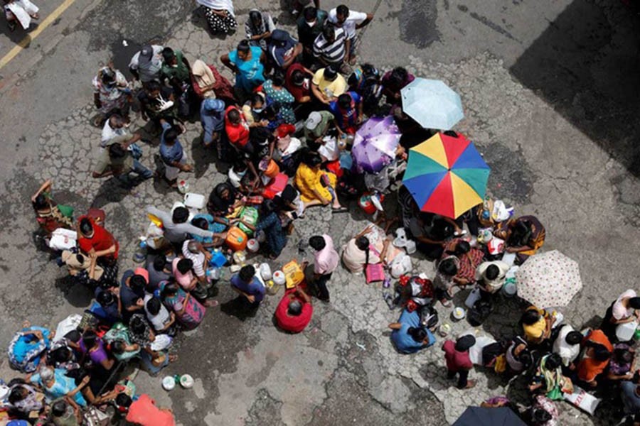 People wait in a queue to buy kerosene at a fuel station, amid the country's economic crisis in Colombo, Sri Lanka, May 18, 2022. REUTERS/Adnan Abidi