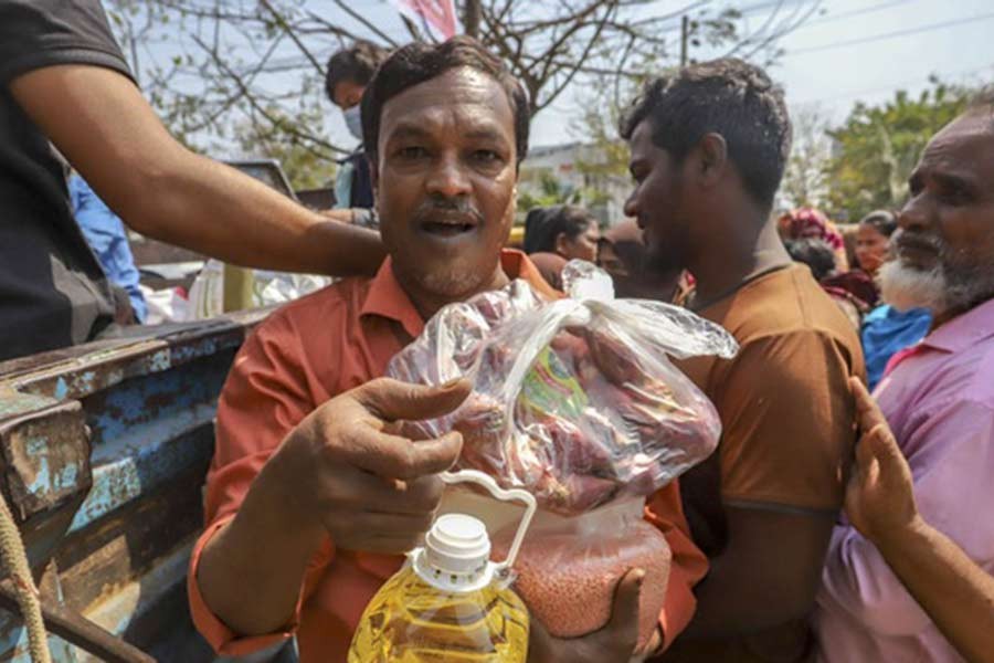 A customer departing after buying sugar, pulses and oil from a TCB truck in Bhashantek recently –bdnews24.com file photo