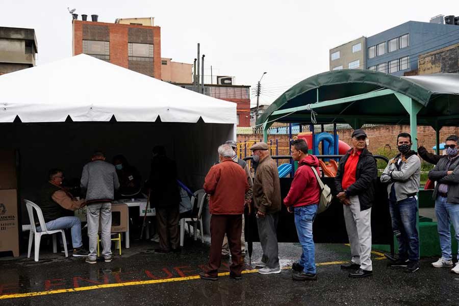 People waiting in line to cast their ballots at a polling station during the first round of the presidential election in Bogota of Colombia on Sunday –Reuters photo