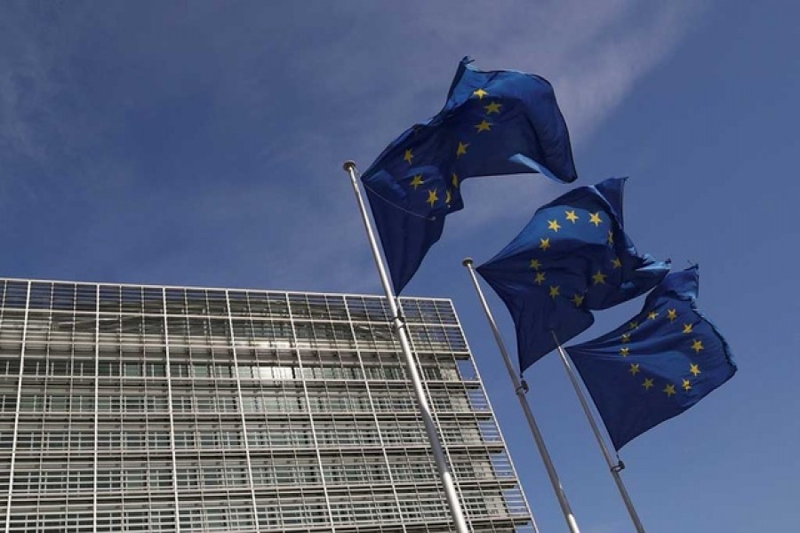 European Union flags flutter outside the European Commission headquarters in Brussels, Belgium, March 24, 2021. REUTERS