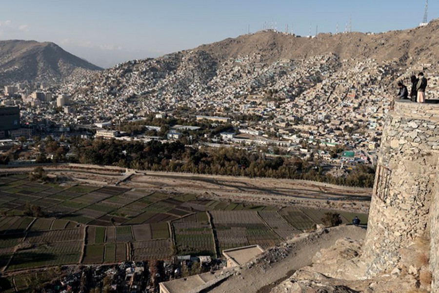 Afghan men enjoy the general view of the city from the top of a hill in Kabul, Afghanistan on November 5, 2021 — Reuters/Files