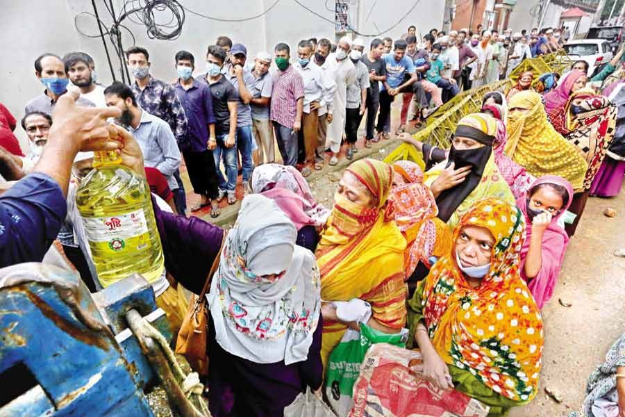 People waiting in queues to buy daily commodities at a TCB sales point near the National Press Club in the city last year — FE file photo