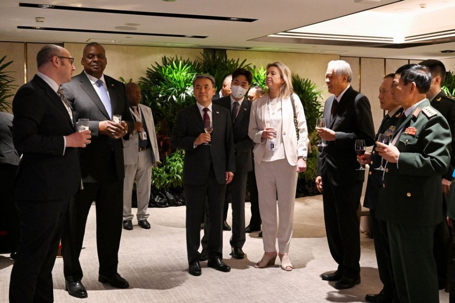 Ukraine Deputy Foreign Minister Dmytro Senik, US Defence Secretary Lloyd Austin, South Korea Defence Minister Lee Jong-sup, Netherlands Defence Minister Kajsa Ollongren, Singapore Defence Minister Ng Eng Hen, China's State Councilor and Defence Minister General Wei Fenghe and Laos' Major General Chanthong Sonetaath chat before the ministerial working lunch during the 19th Shangri-La Dialogue in Singapore June 11, 2022. REUTERS/Caroline Chia