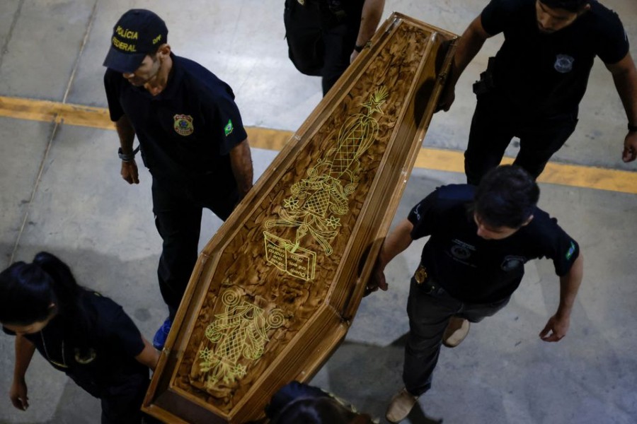 Federal Police officers carry a coffin containing human remains after a suspect confessed to killing British journalist Dom Phillips and Brazilian indigenous expert Bruno Pereira and led police to the location of remains, at the headquarters of the Federal Police, in Brasilia, Brazil on June 16, 2022 — Reuters photo