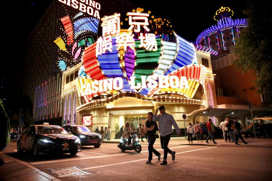 People walk in front of Casino Lisboa in Macau, China December 21, 2019. REUTERS/Jason Lee/File Photo