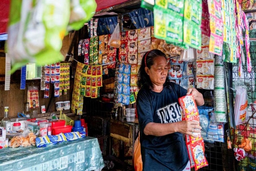 Maria Aurelio, 55, prepares to display plastic sachets of Unilever's Surf laundry detergent at her sundry store in Manila, Philippines, May 31, 2022. Picture taken May 31, 2022. Reuters