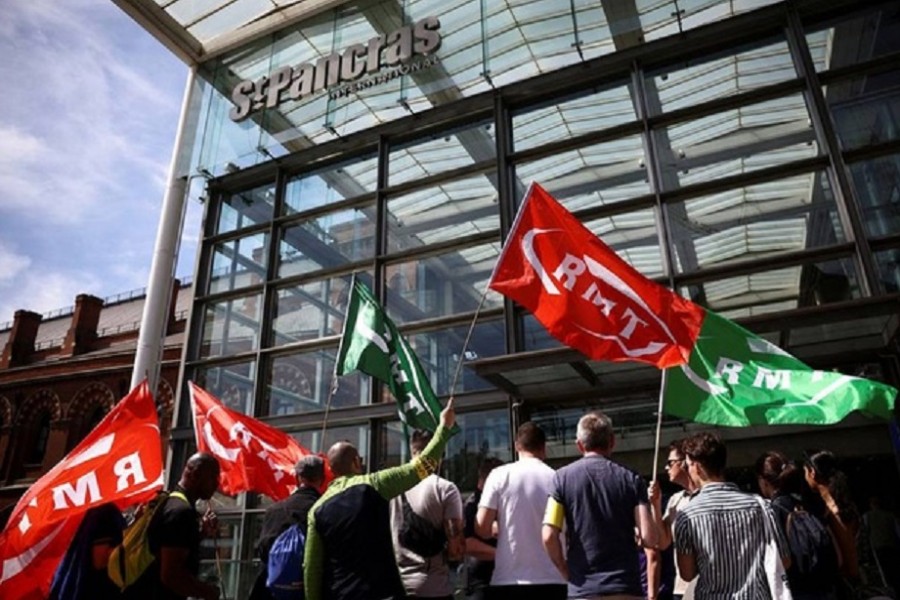 People protest outside St Pancras International railway station on the first day of national rail strike in London, Britain, June 21, 2022. REUTERS/Henry Nicholls