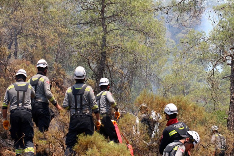 Firefighters work to extinguish a wildfire near Marmaris, a town in Mugla province, Turkey, June 23, 2022. REUTERS/Kenan Gurbuz