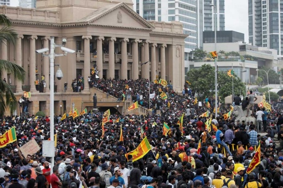 Demonstrators celebrate after entering into the Presidential Secretariat, after President Gotabaya Rajapaksa fled, amid the country's economic crisis, in Colombo, Sri Lanka Jul 9, 2022. Reuters