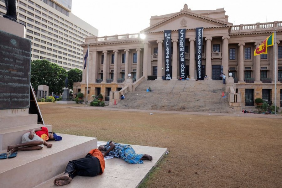 Demonstrators sleep at the Presidential Secretariat after Parliament Speaker Mahinda Yapa Abeywardena officially announced the resignation of president Gotabaya Rajapaksa who fled to Singapore amid Sri Lanka's economic crisis, in Colombo, Sri Lanka, July 15, 2022. REUTERS/Dinuka Liyanawatte