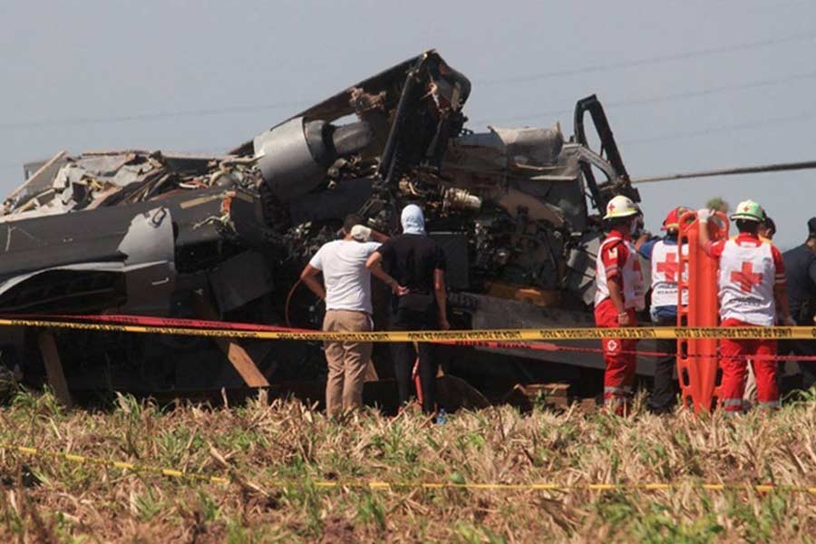 Red Cross paramedics standing next to the wreckage of a Black Hawk military helicopter that crashed in Los Mochis in Sinaloa state of Mexico on Friday –Reuters photo