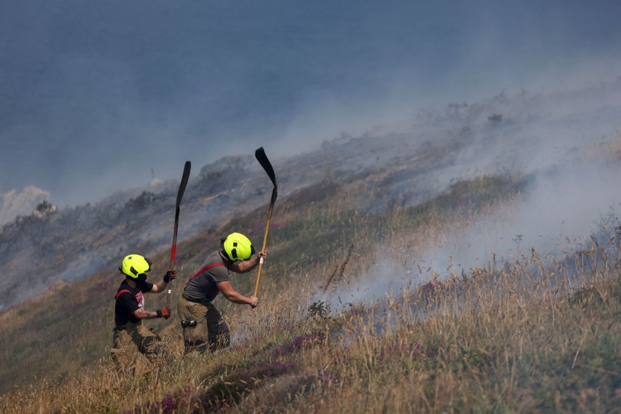 Firefighters attend a gorse bush fire, during a heatwave near Zennor, Cornwall, Britain on July 19, 2022 — Reuters photo