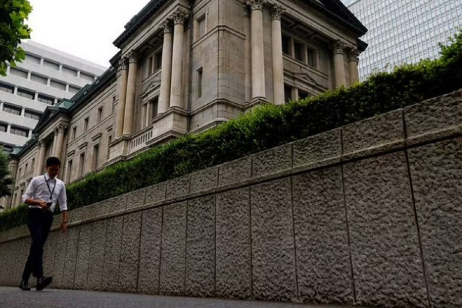 A man walks past Bank of Japan's headquarters in Tokyo, Japan, June 17, 2022. Reuters