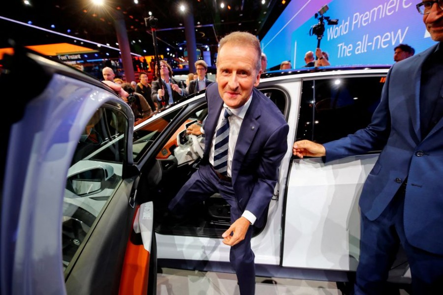 Herbert Diess, CEO of German carmaker Volkswagen AG, poses in an ID.3 pre-production prototype during the presentation of Volkswagen's new electric car on the eve of the International Frankfurt Motor Show IAA in Frankfurt, Germany September 9, 2019. REUTERS/Wolfgang Rattay/File Photo