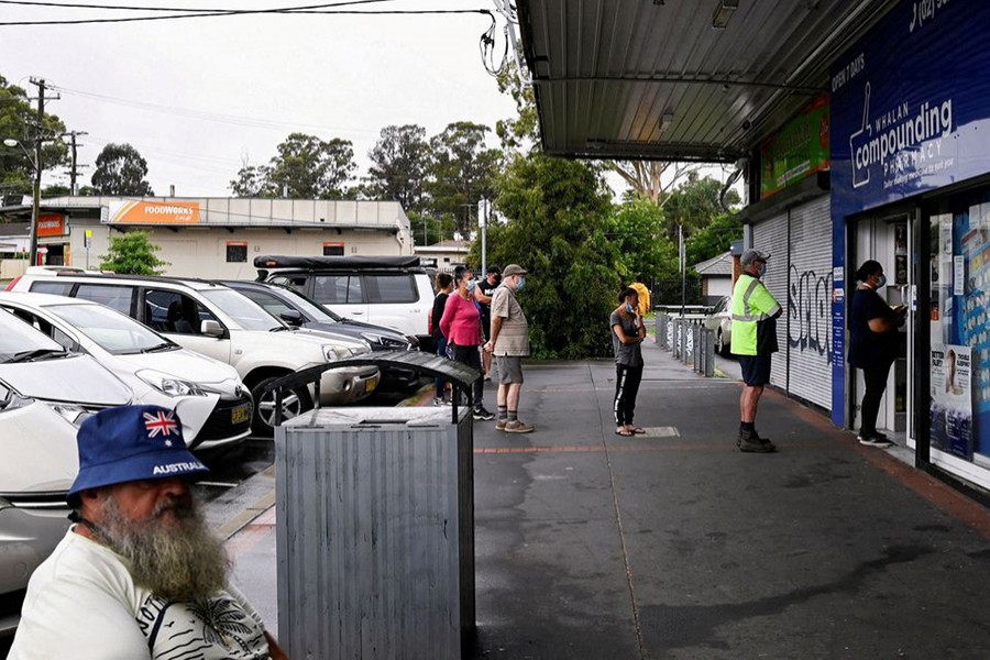 Customers queue outside a Western Sydney chemist to purchase Rapid Antigen Test kits in the wake of the coronavirus disease (Covid-19) pandemic in Sydney, Australia on January 5, 2022 — Reuters/Files