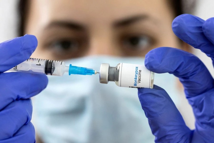 A woman holds a mock-up vial labelled "Monkeypox vaccine" and medical syringe in this illustration taken on May 25, 2022 — Reuters/Files