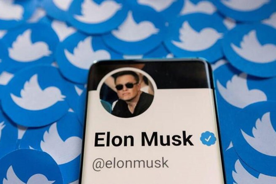 Elon Musk's Twitter profile is seen on a smartphone placed on printed Twitter logos in this picture illustration — Reuters/Files