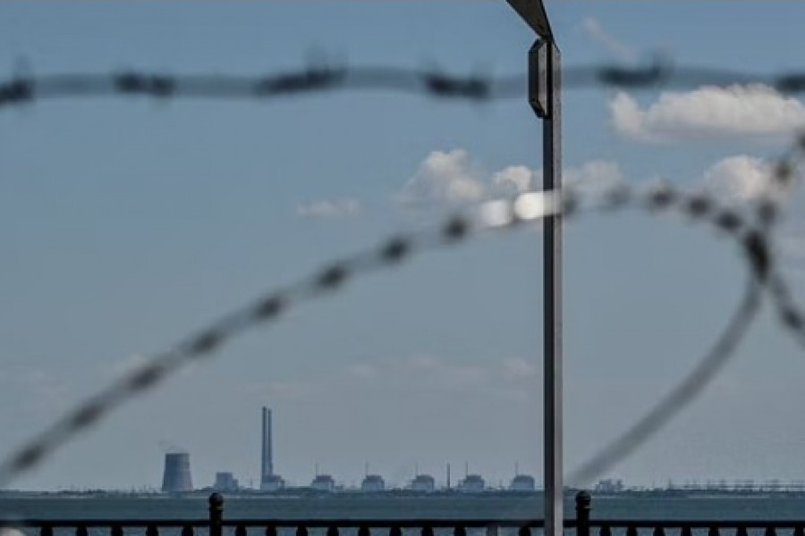 Zaporizhzhia Nuclear Power Plant is seen from an embankment of the Dnipro river in the town of Nikopol, as Russia's attack on Ukraine continues, in Dnipropetrovsk region, Ukraine Jul 20, 2022. REUTERS/Dmytro Smolienko