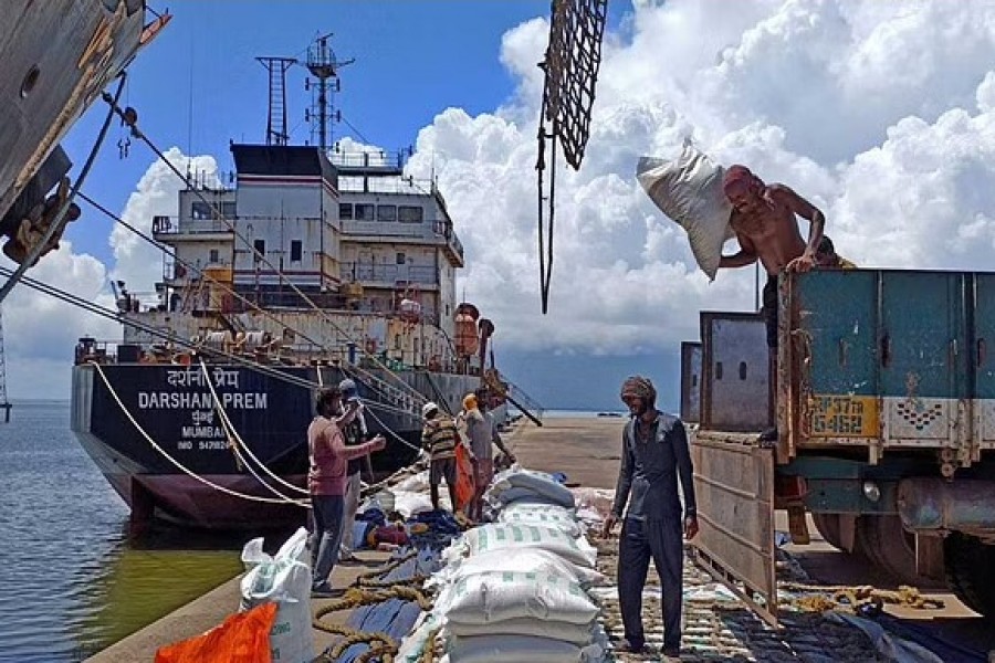 Labourers unload rice bags from a supply truck at India's main rice port at Kakinada Anchorage in the southern state of Andhra Pradesh, India, September 2, 2021. Reuters