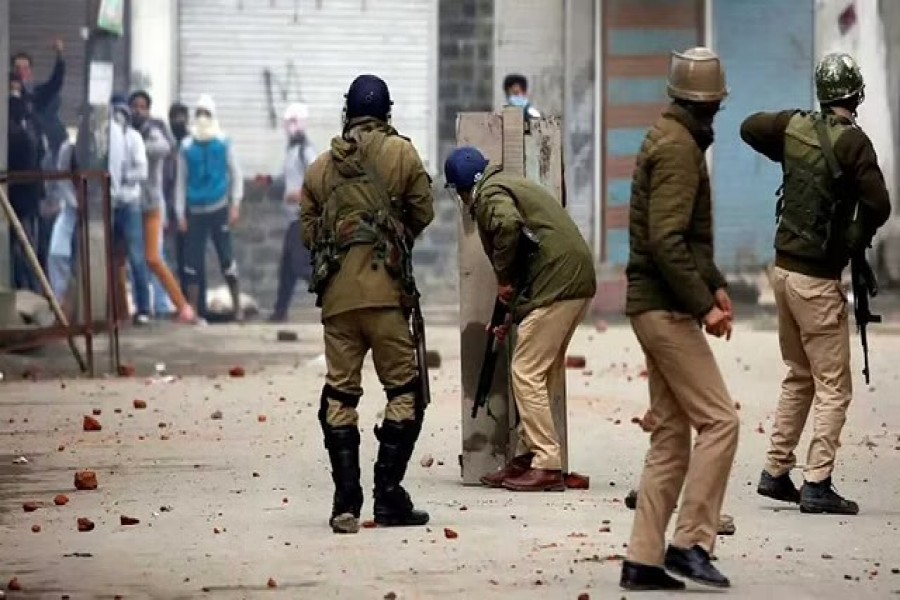 Indian police officers take cover during clashes with Kashmiri demonstrators during a protest against the killing of Zakir Rashid Bhat also known as Zakir Musa, the leader of an al Qaeda affiliated militant group in Kashmir, in Srinagar May 24, 2019. REUTERS