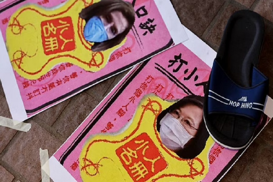 A shoe is placed next to images of US House of Representatives Speaker Pelosi and Taiwan President Ing-wen, during a protest, in Hong Kong. REUTERS