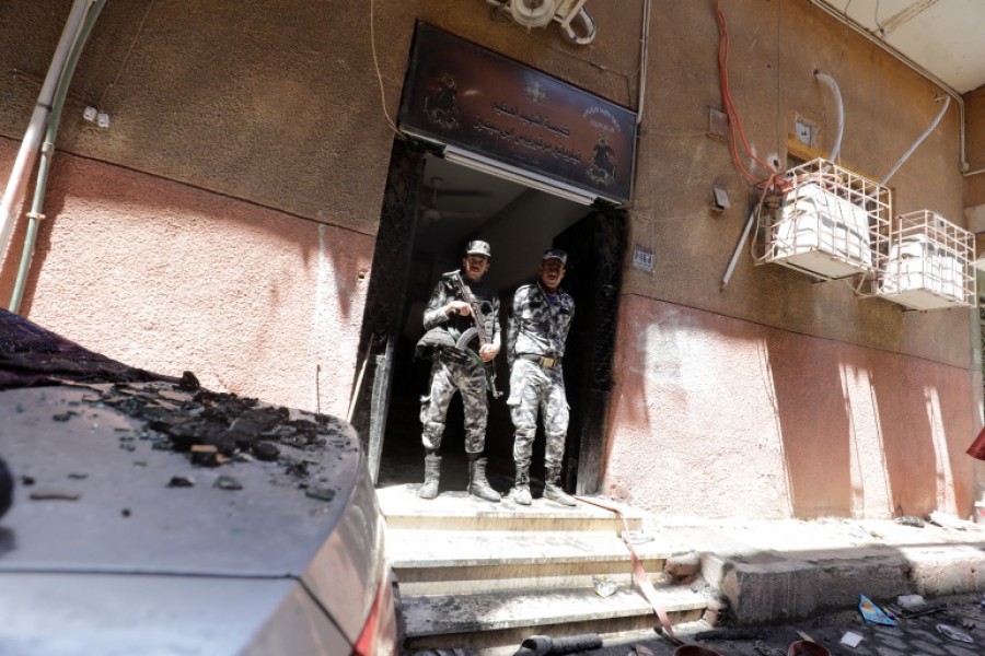 Security members stand at the scene where a deadly fire broke out at the Abu Sifin church in Giza, Egypt [Mohamed Abd el-Ghany/Reuters]